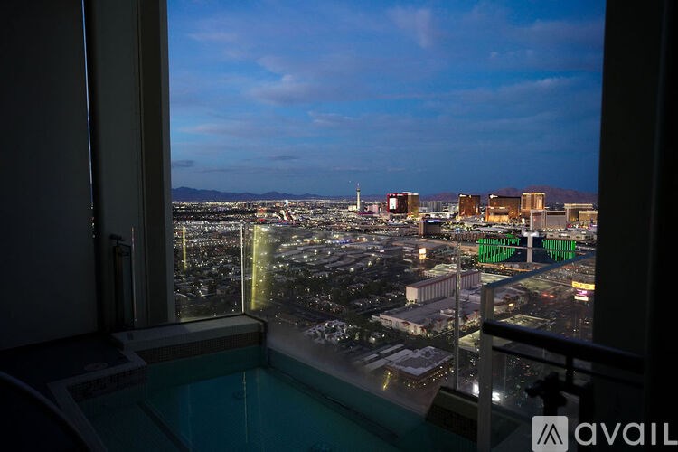 A view from a window overlooking a city at night.