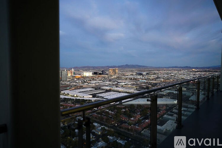 A view from a balcony overlooking a cityscape.