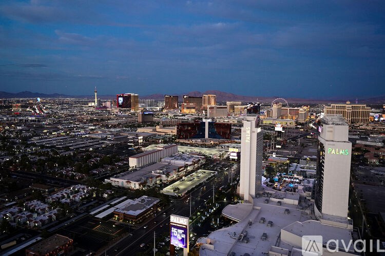 A cityscape with a large white tower in the center.