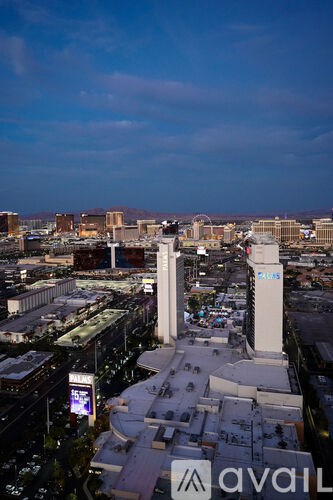 A cityscape with a tall tower in the center and buildings surrounding it.
