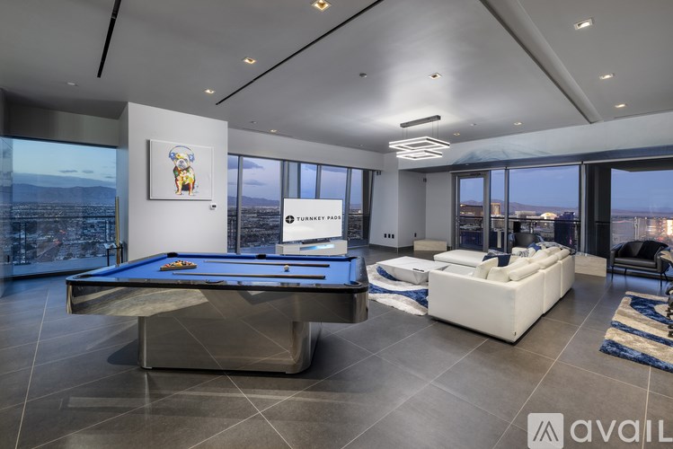 A room with a pool table and a couch.