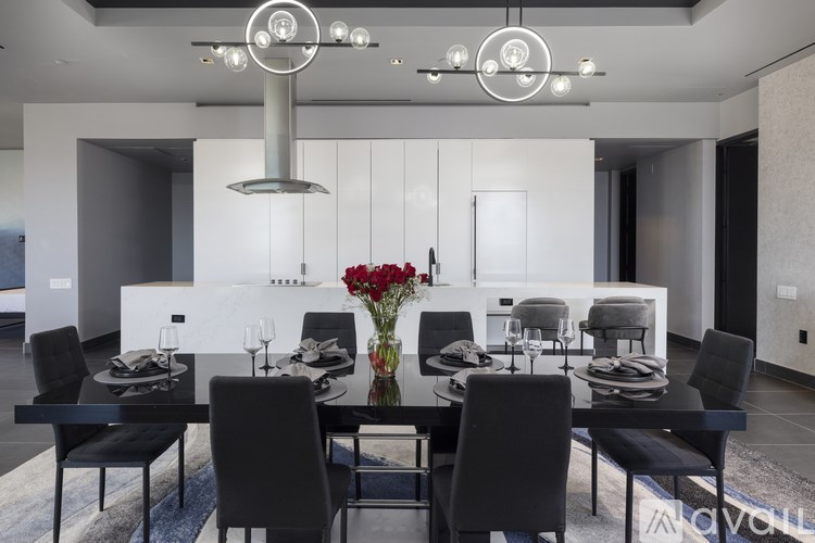 A modern dining room with a long table set for six.
