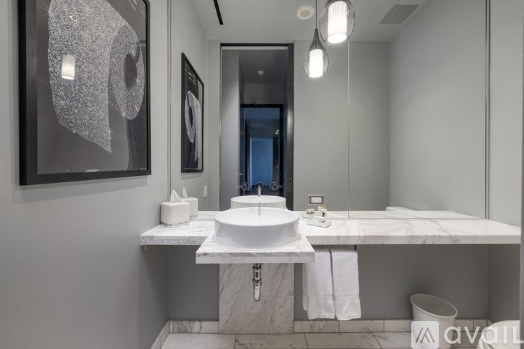 A bathroom with a white sink and a mirror above it.