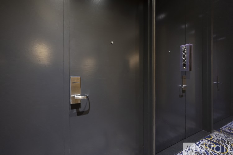 A modern elevator with a digital display showing the floor number 12.