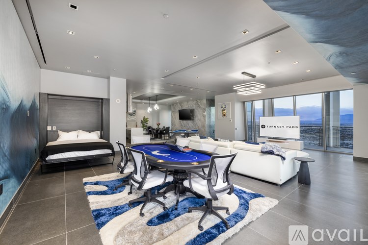 A modern room with a blue table and chairs.