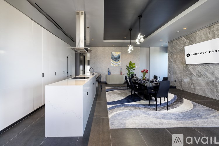 A modern kitchen with a dining table set up.