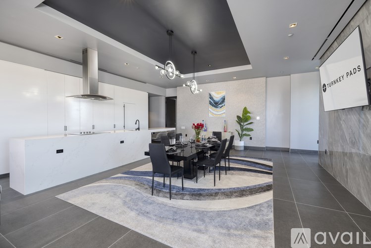 A modern dining room with a black table and chairs.