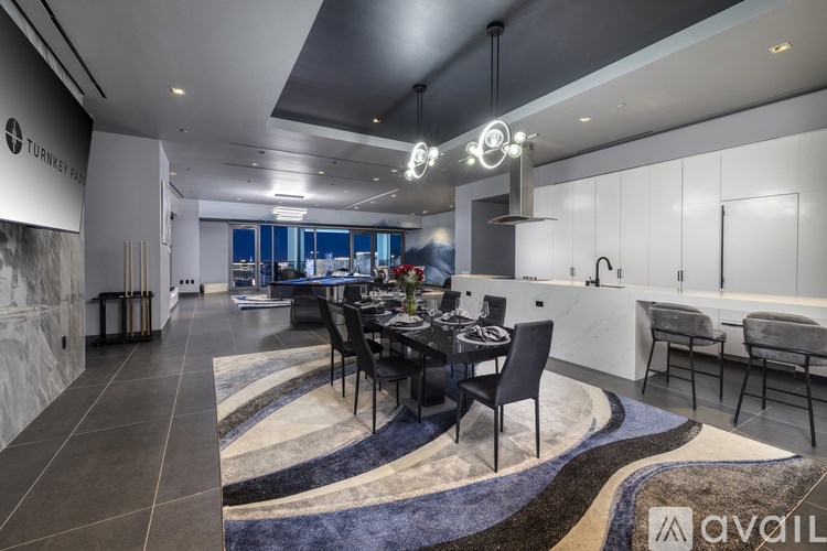 A modern dining area with a black table and chairs.