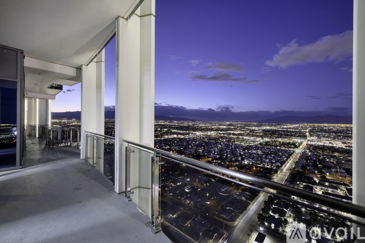 A balcony with a view of a city at night.