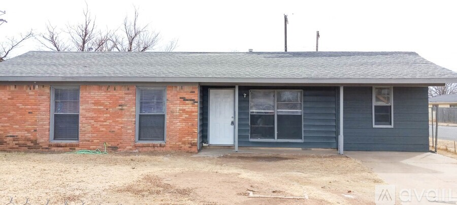 A small house with a white door and a grey roof.