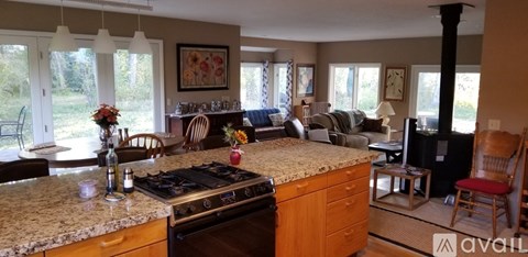 A kitchen with a stove top oven and a counter top.