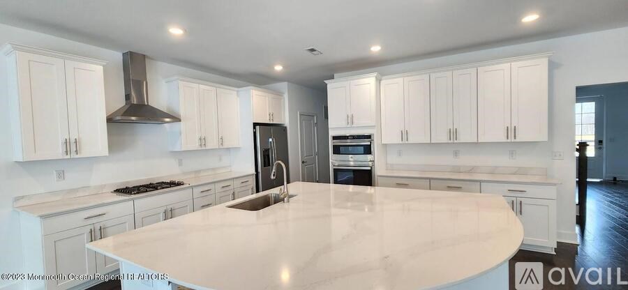 A kitchen with a large island in the middle.