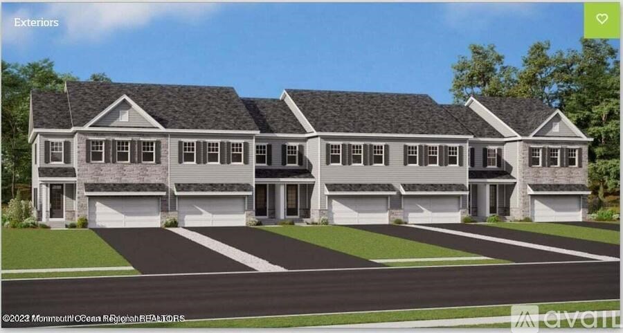 A modern house with a large front yard and two garages.