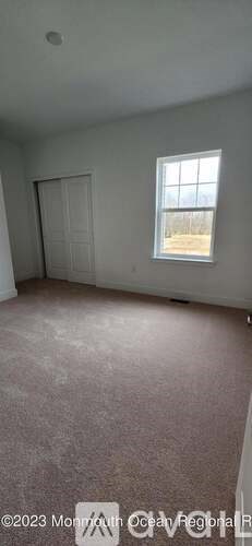 A room with a window and a door.