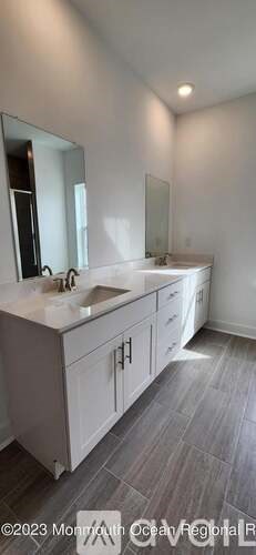 A bathroom with a sink and a mirror.