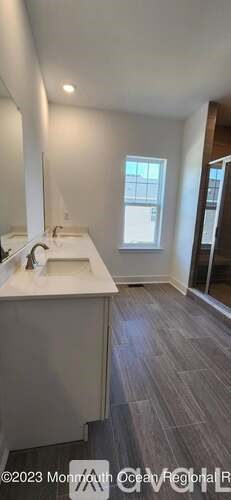 A bathroom with a sink and a mirror.