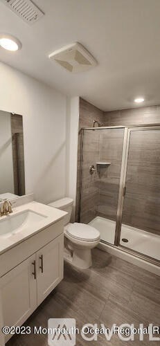 A bathroom with a toilet, sink, and shower.