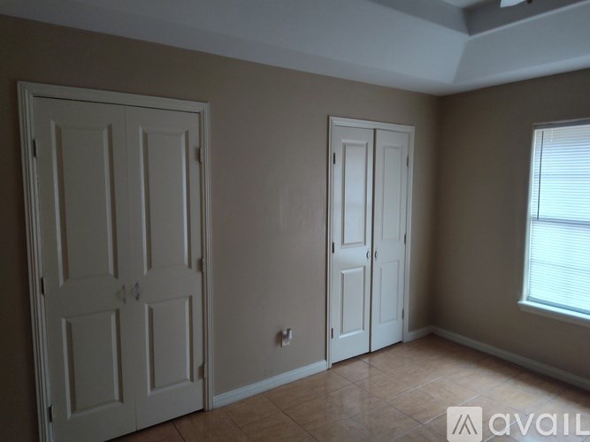 A room with two doors and a window.