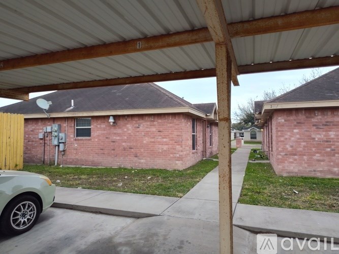 A car is parked under a covered walkway.