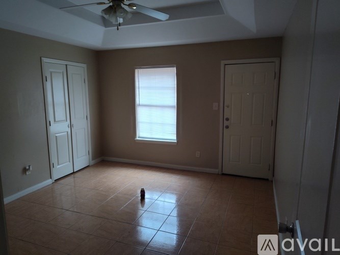 A room with a ceiling fan and a window.