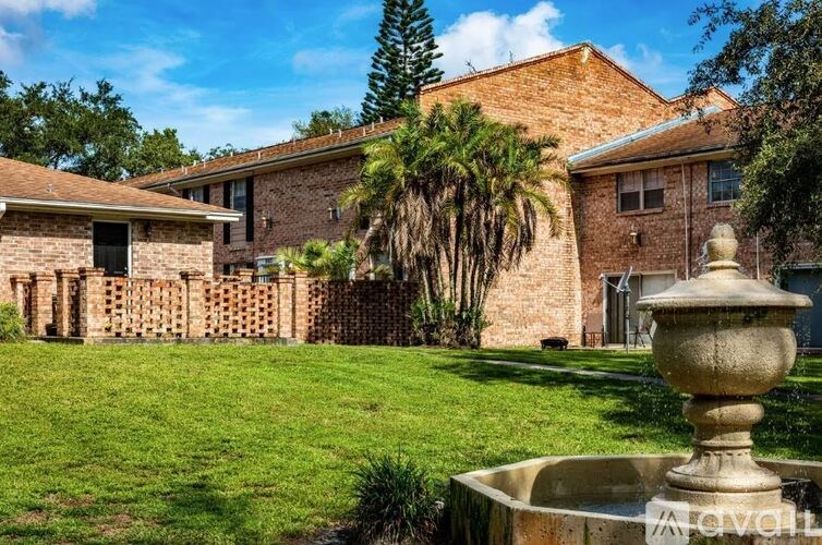 A house with a fountain in front of it.
