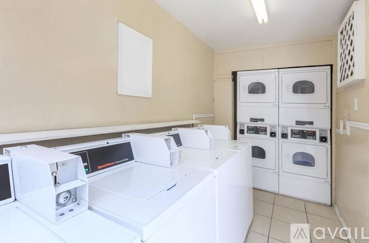A white kitchen with a white oven and white appliances.