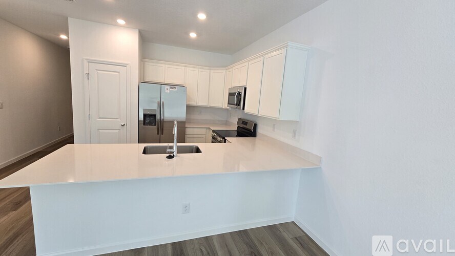 A kitchen with white cabinets and a countertop.