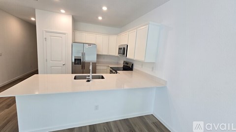A kitchen with white cabinets and a countertop.