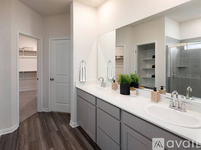 A bathroom with a white countertop and a large mirror.
