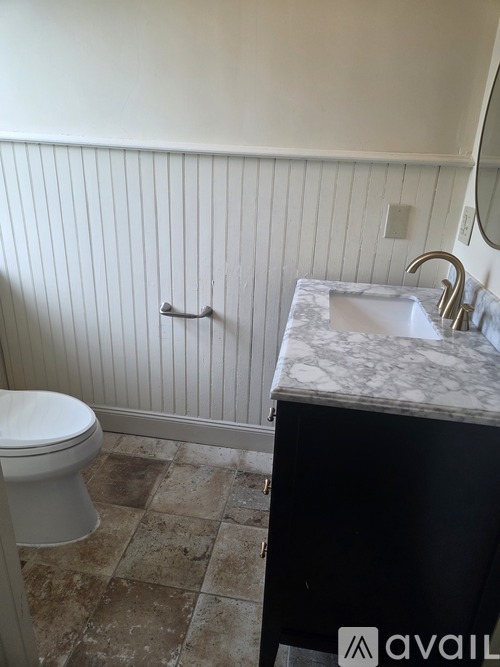 A kitchen with a stove, oven, and two washing machines.