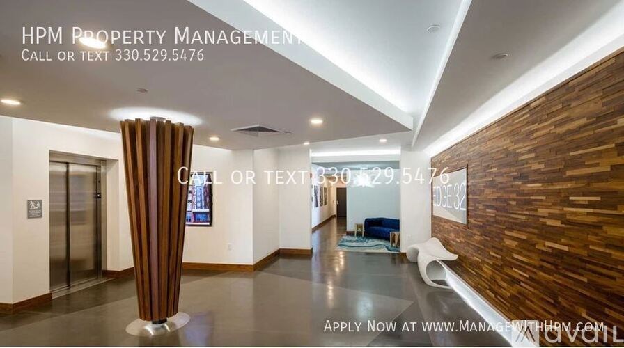 A modern office lobby with a wooden wall and a curtained entrance.