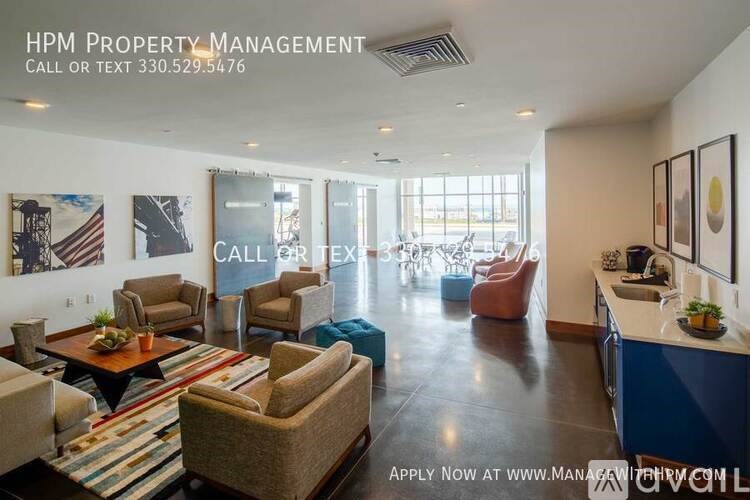 A living room with a couch, chairs, and a coffee table.