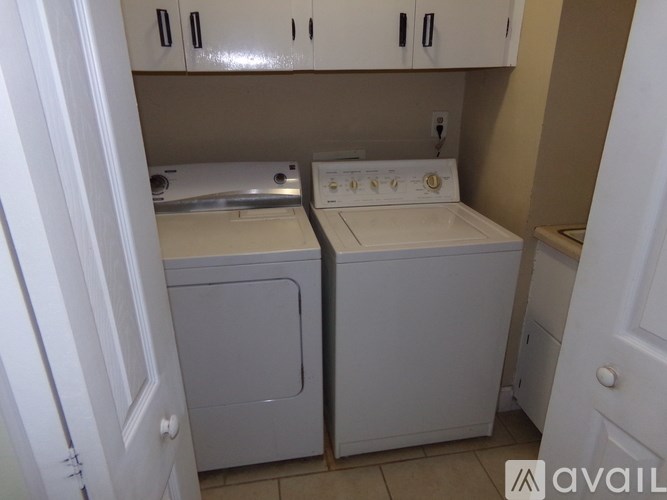 A small laundry room with a washer and dryer.