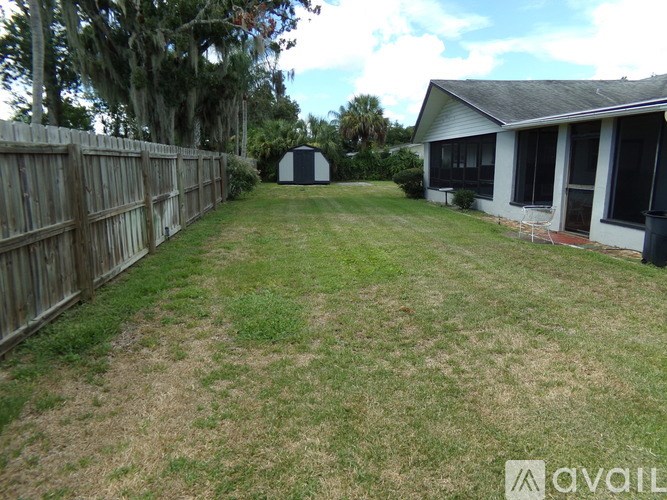 A backyard with a wooden fence and a shed.