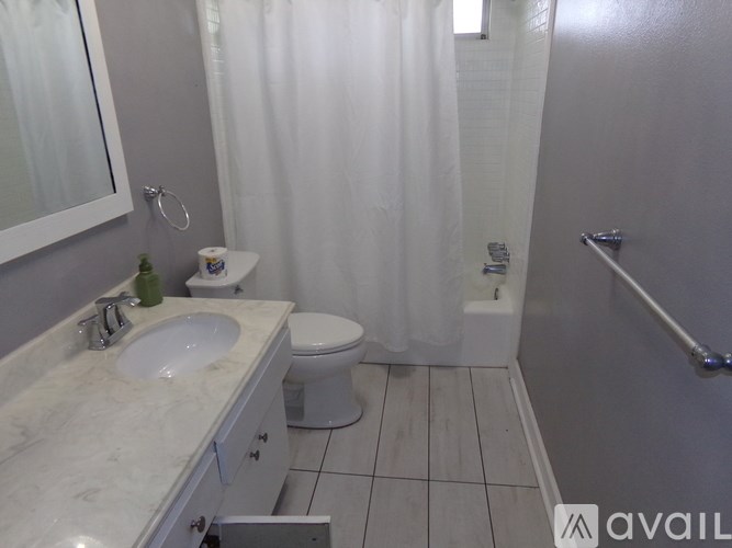 A bathroom with a toilet, sink, and shower.