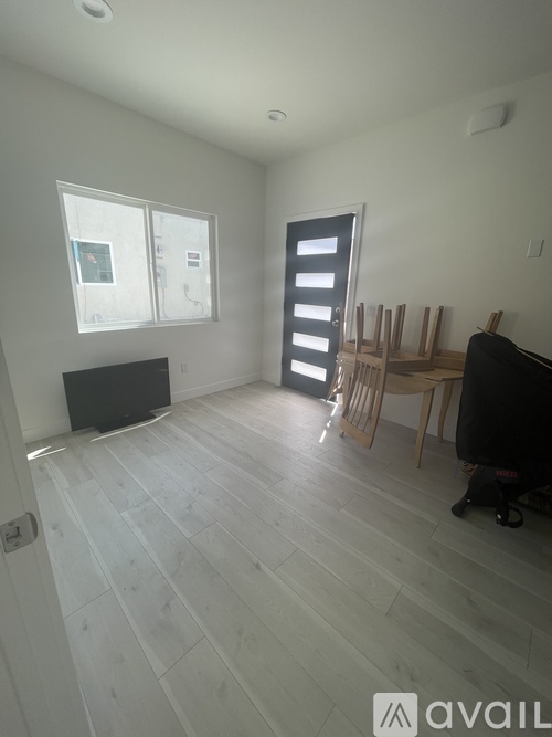 A room with a wooden floor and a blackboard on the wall.