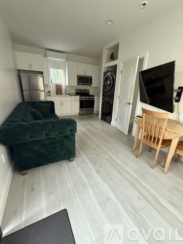 A living room with a green sofa and a wooden table.