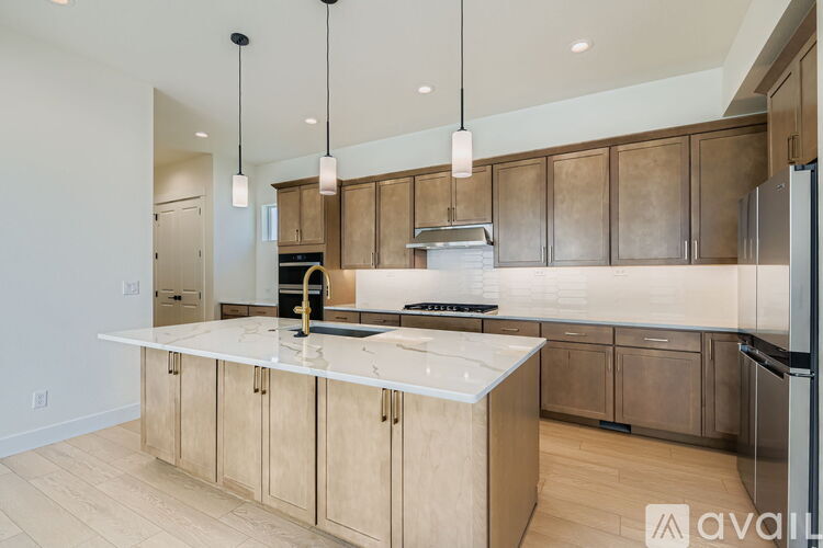 A kitchen with wooden cabinets and a marble countertop.