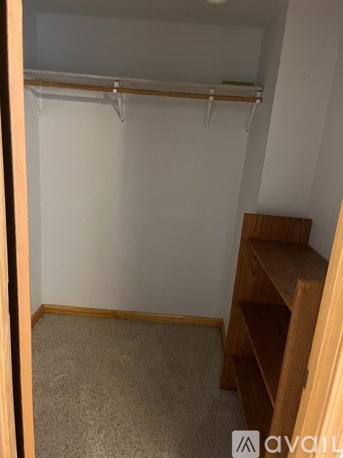 A small room with a shelf and a closet.