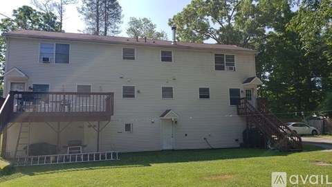 A two-story house with a balcony on the upper floor.