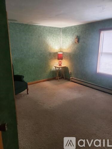 A room with green walls and a red lamp.