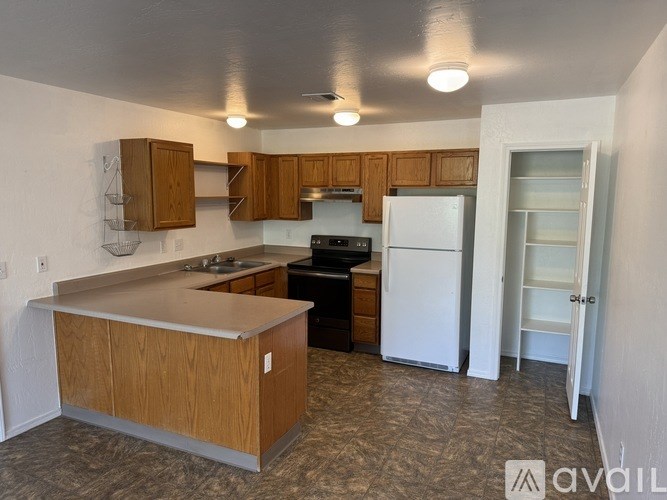 A kitchen with white appliances and cabinets.