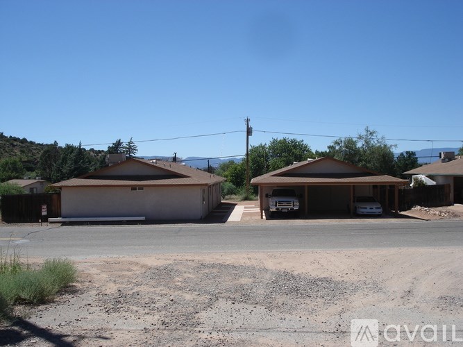 Two houses with a clear blue sky above them.