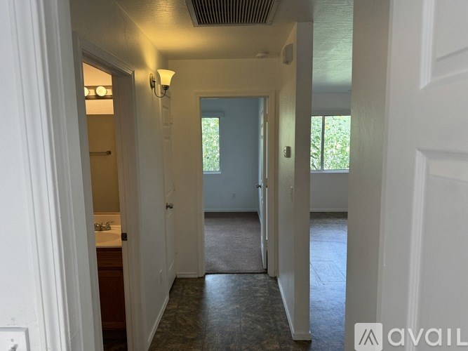 Two white front loading washing machines in a small laundry room.