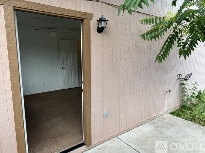 A room with a ceiling fan and a carpeted floor.