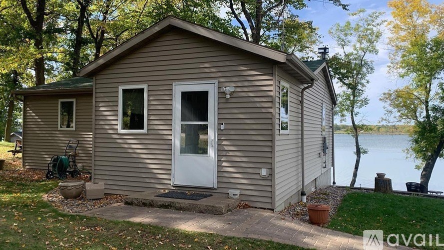 A small house with a white door is available for rent.
