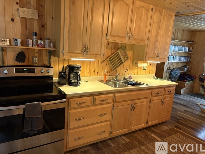 A kitchen with wooden cabinets and a stove top oven.