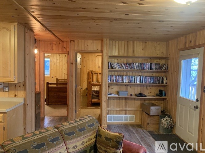 A living room with wooden walls and a couch.