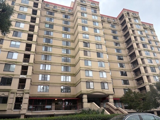 A large beige building with many windows and balconies.