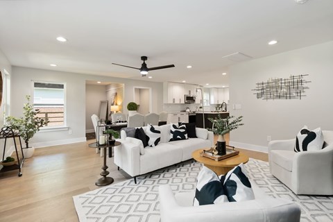 A modern living room with a white sofa and a coffee table.